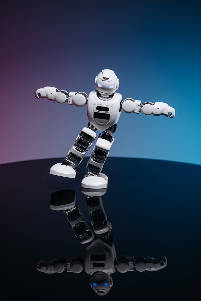 A white robot toy posed dynamically on a glossy reflective surface with a gradient background.